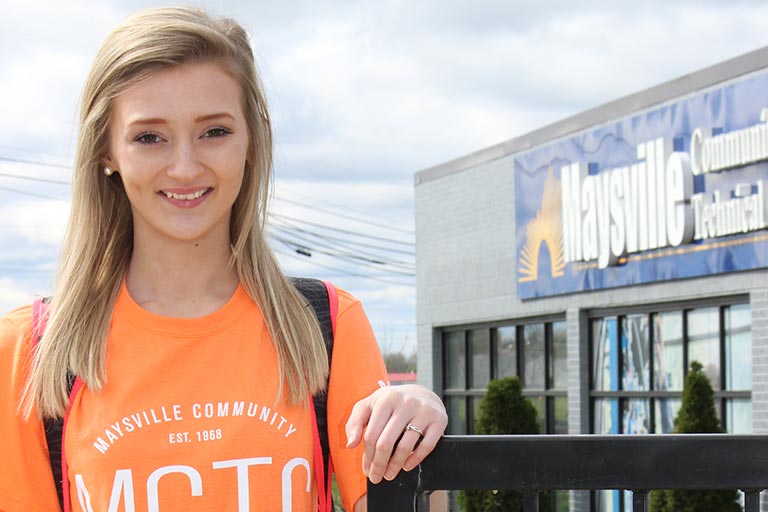 female student wearing a MCTC sweatshirt and standing in front of MCTC