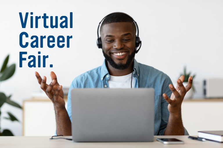 student in front of a computer with headset on