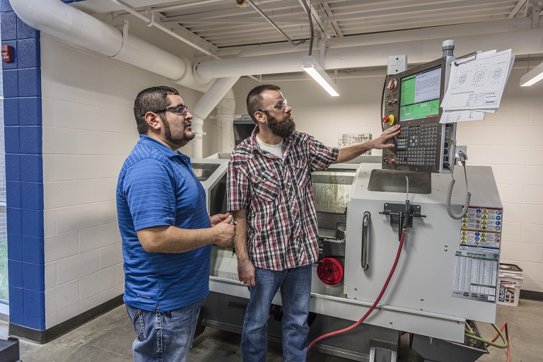 two men looking at a large machine