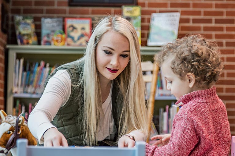 woman teaching a child
