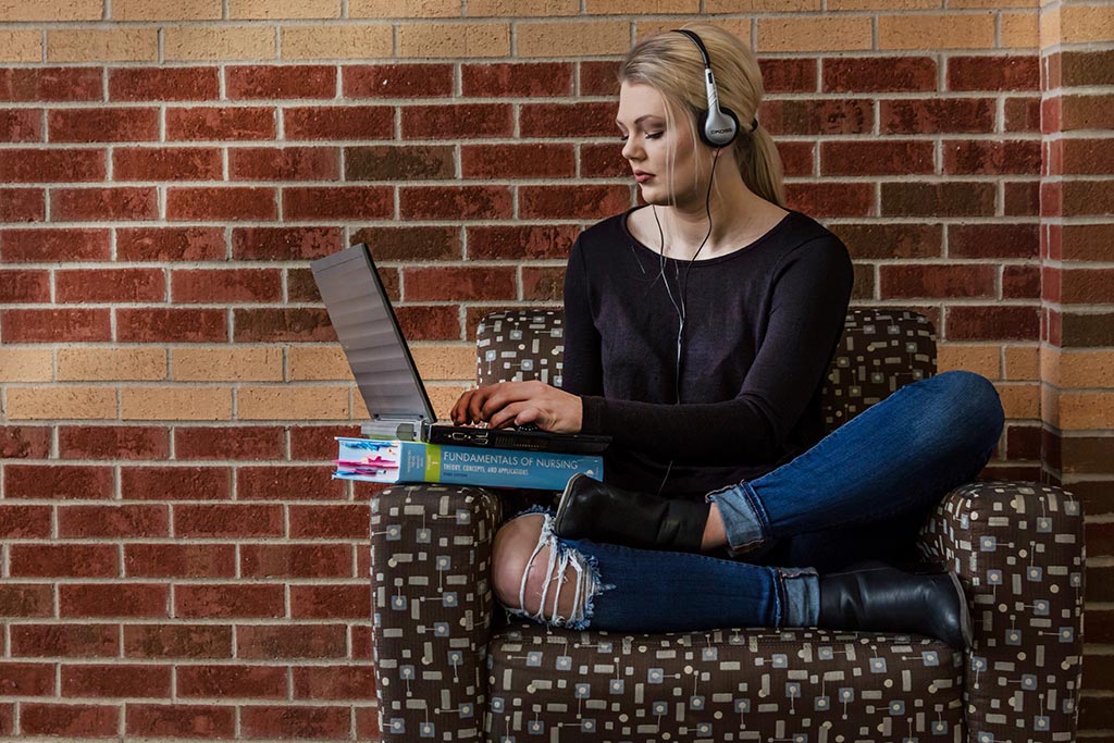 girl in chair on laptop